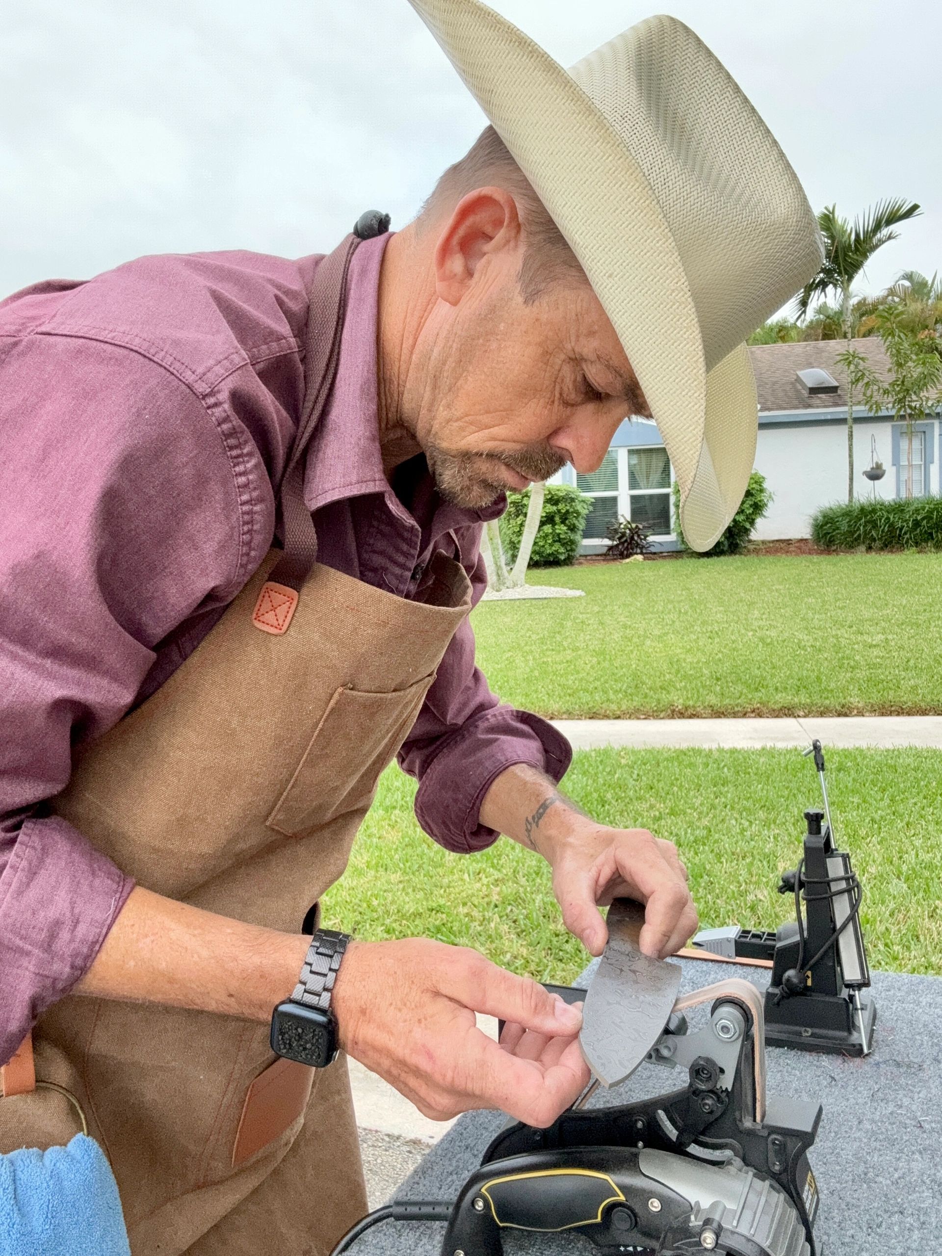 Travis Pappenheim sharpening a blade on-site